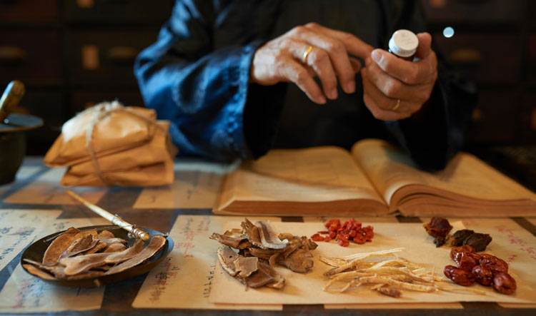 chinese medicine practitioner making a remedy